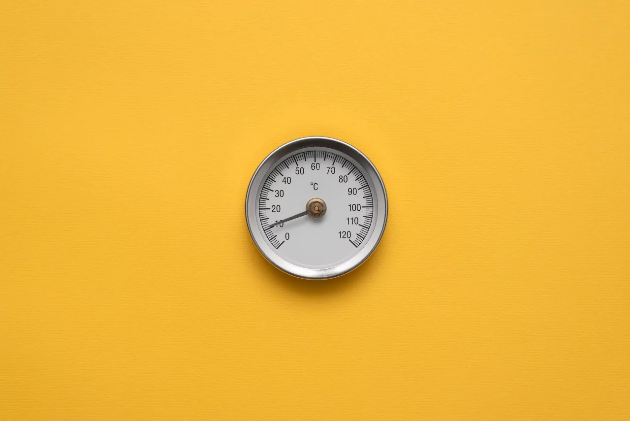 Picture of temperature gauge on a yellow background